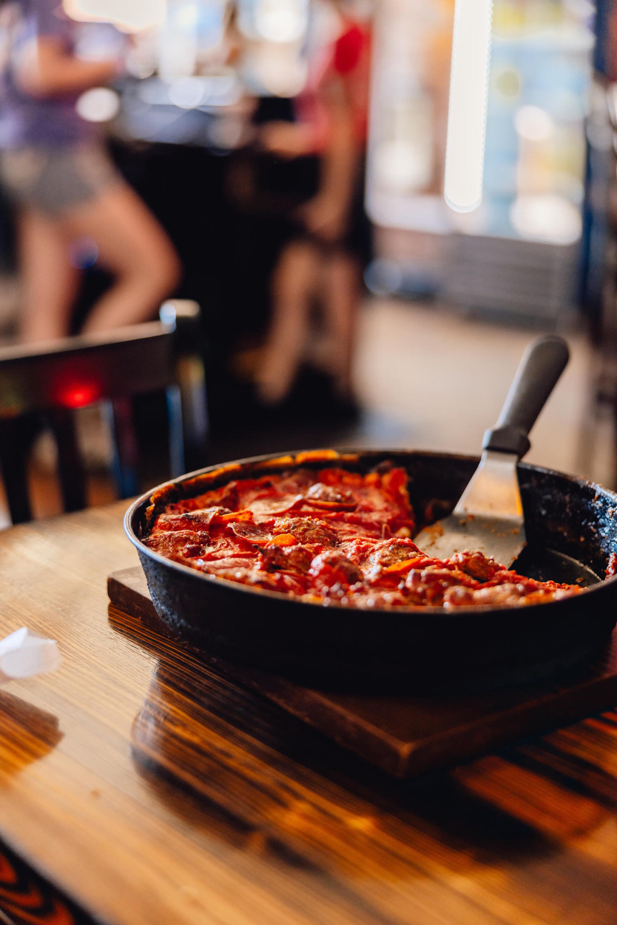 Deep dish pizza served in a cast iron skillet at a local restaurant near Ashford at Geneva apartments in Geneva, IL