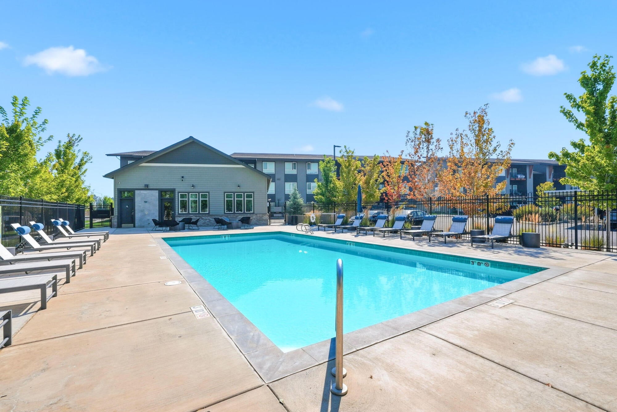Seasonal heated swimming pool and sundeck in front of the clubhouse at Cypress in Redmond, Oregon.