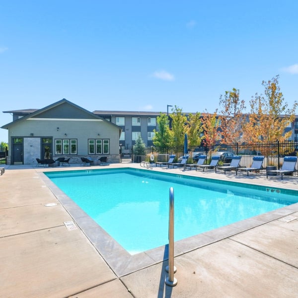 Seasonal heated swimming pool and sundeck in front of the clubhouse at Cypress in Redmond, Oregon.