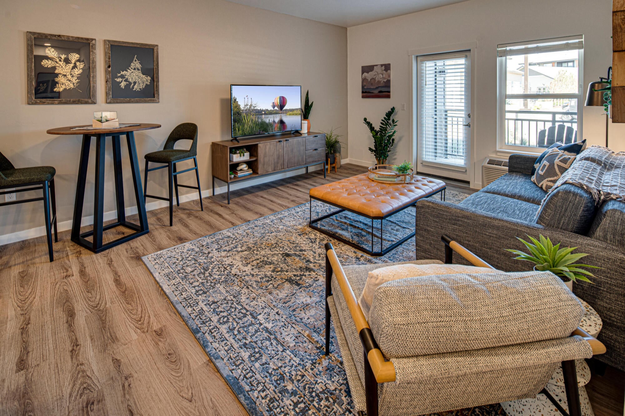 Wide view of a furnished model great room in a three bedroom home at Cypress in Redmond, Oregon.