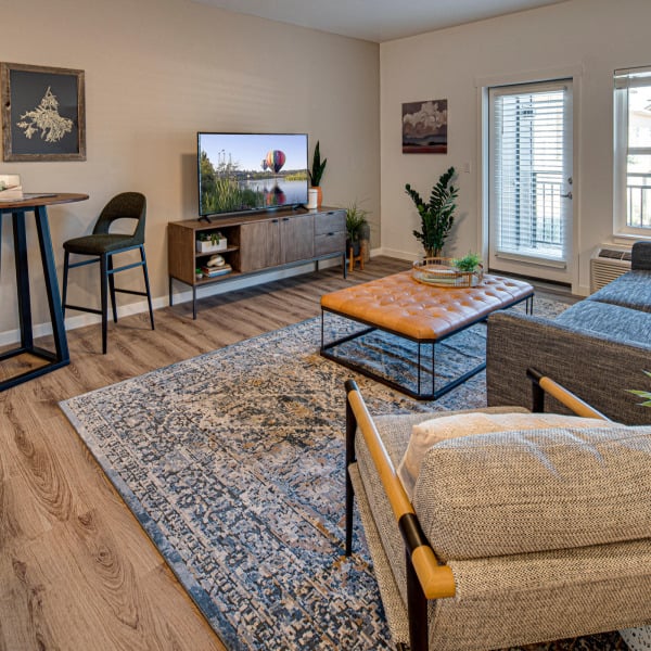 Wide view of a furnished model great room in a three bedroom home at Cypress in Redmond, Oregon.
