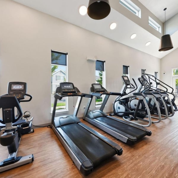 Row of treadmills, ellipticals, and bikes in the fitness center at Cypress in Redmond, Oregon.