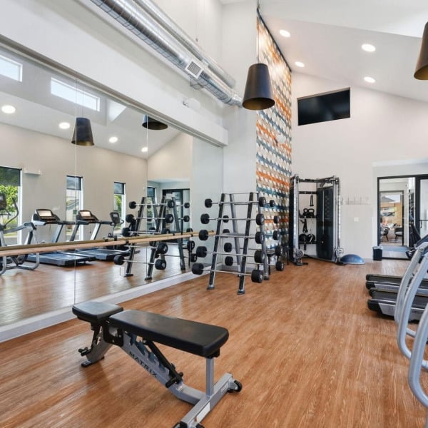 On-site 24-hour fitness center with mirrored walls and strength equipment at Cypress in Redmond, Oregon.