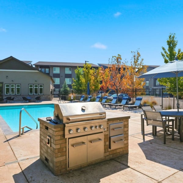 Built-in gas grilling station overlooking the seasonal pool at Cypress in Redmond, Oregon.