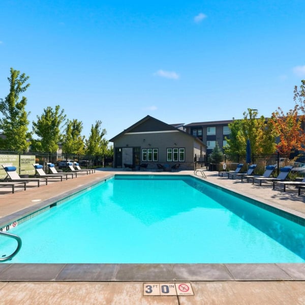 Poolside seating along the length of the pool at Cypress apartments in Redmond, Oregon.
