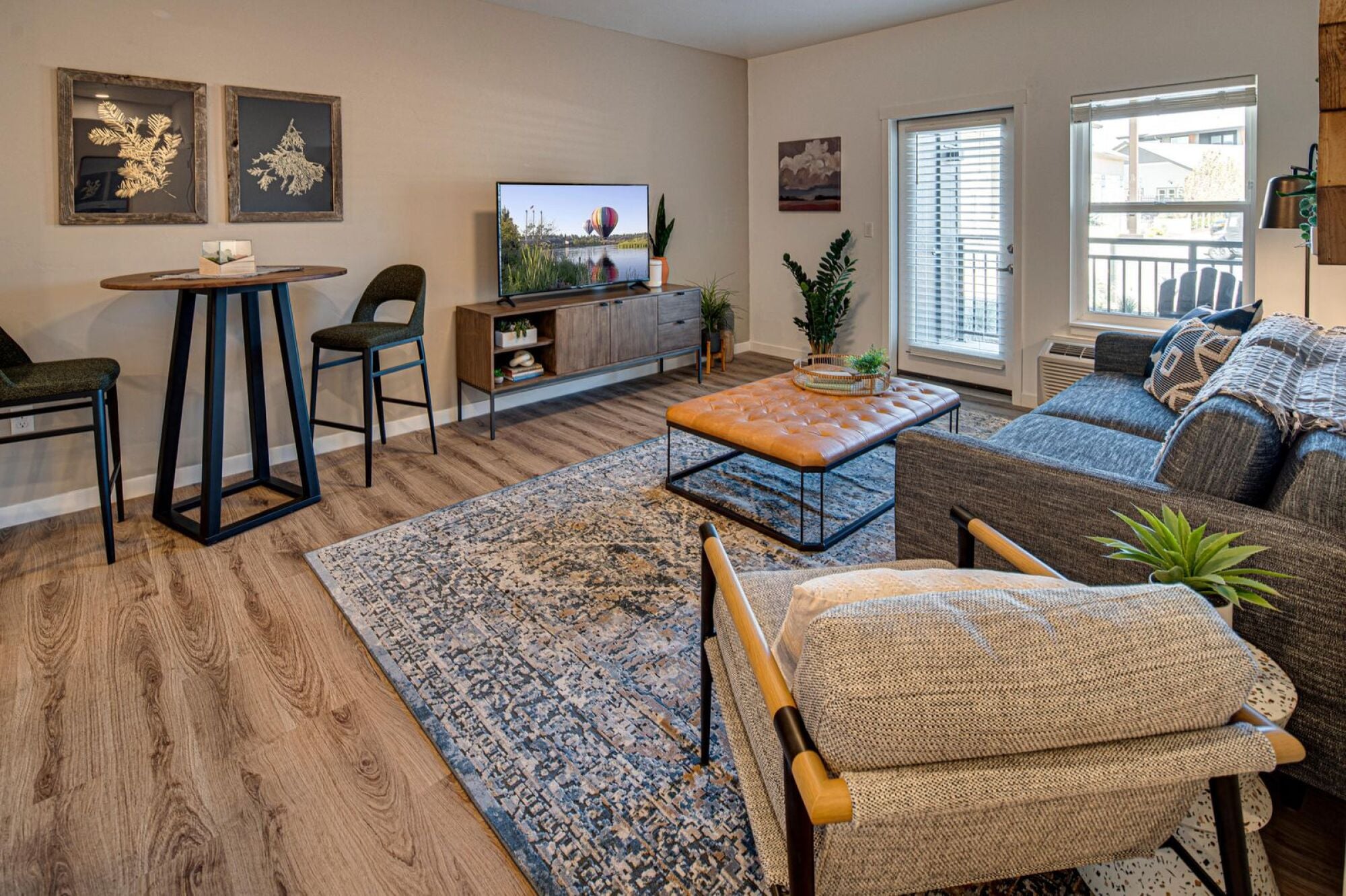 Wide view of a furnished model great room in a three bedroom home at Cypress in Redmond, Oregon.