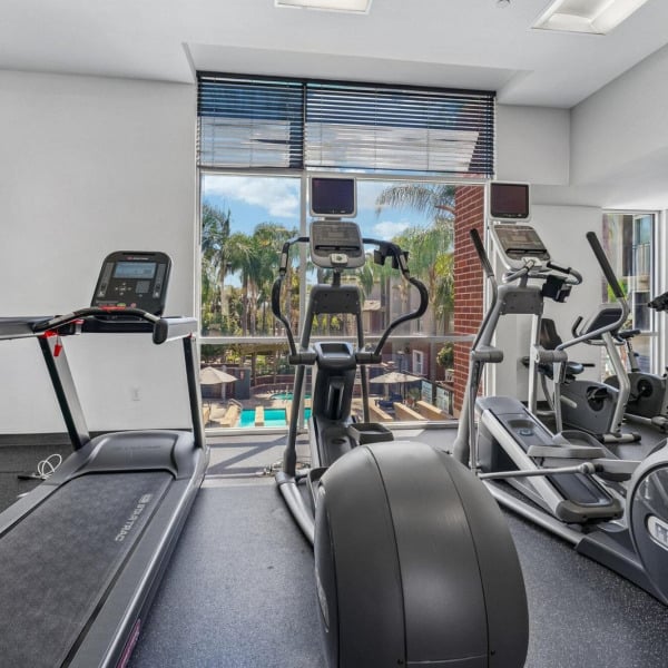 Treadmills and ellipticals overlooking the pool at Ontario Town Square Townhomes in Ontario, CA.