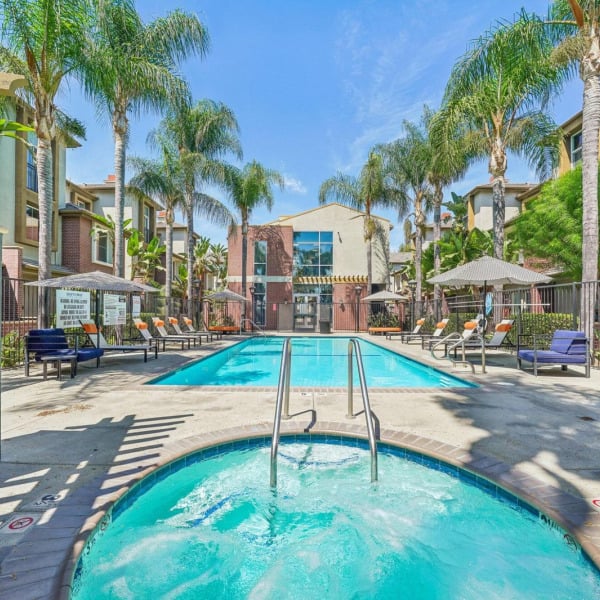 Spa and swimming pool at Ontario Town Square Townhomes in Ontario, CA, with the townhome buildings rising behind.
