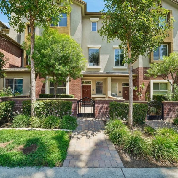 Tree-shaded entry path to the townhomes at Ontario Town Square Townhomes in Ontario, CA.