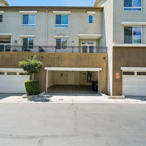 Attached private garages and driveway at Ontario Town Square Townhomes in Ontario, California.