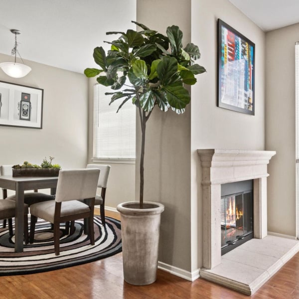 Dining room beside the fireplace in a townhome at Ontario Town Square Townhomes in Ontario, CA.