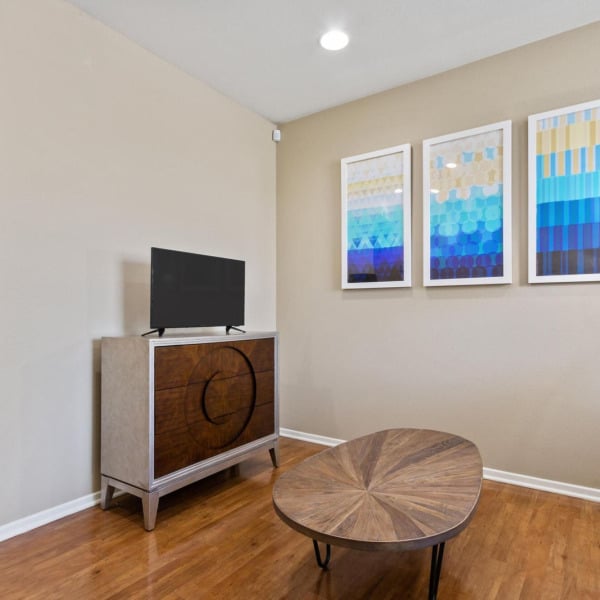 Living area with wood-style plank flooring in a townhome at Ontario Town Square Townhomes in Ontario, CA.
