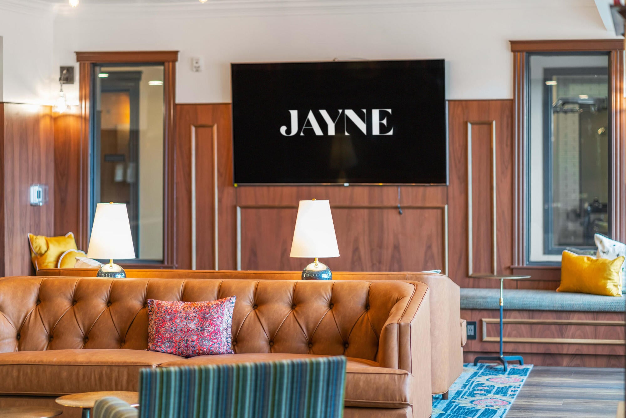 A wall-mounted TV and plush sofa make Jayne's media room in Denver's Baker neighborhood a favorite spot for residents to unwind.