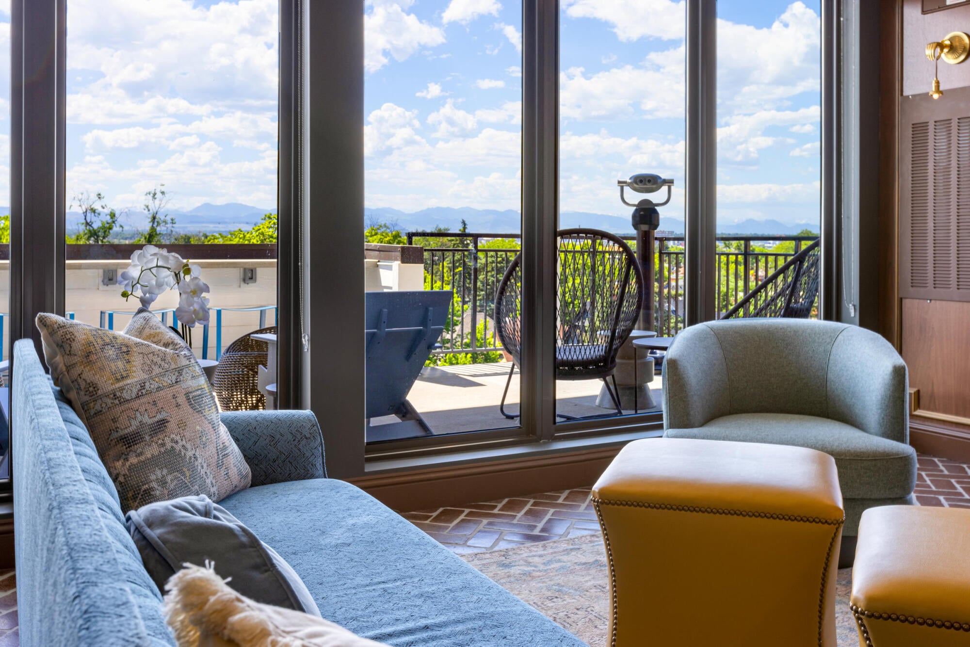 A patio door connects the sunroom lounge to the outdoors at Jayne apartments in Denver's Baker neighborhood.