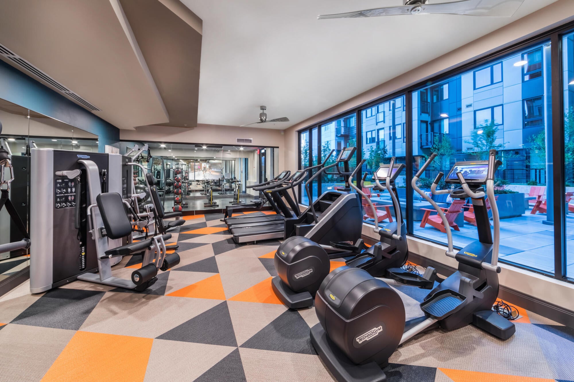 Cardio equipment in Sandy Lofts' fitness center in Portland, OR, offering treadmills and machines for daily resident workouts.