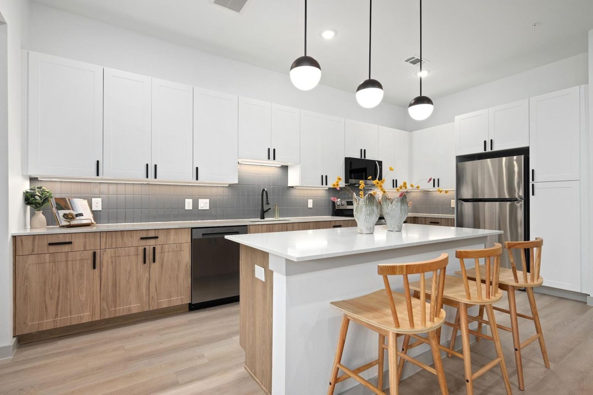 Fully Equipped Kitchen with Two-Toned Cabinetry at Wixby House in Austin, TX