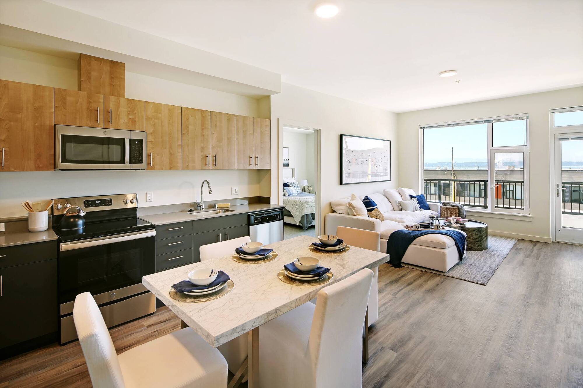 A furnished kitchen and dining area with coastal-inspired decor at Waterfront Place Apartments in Everett, WA.