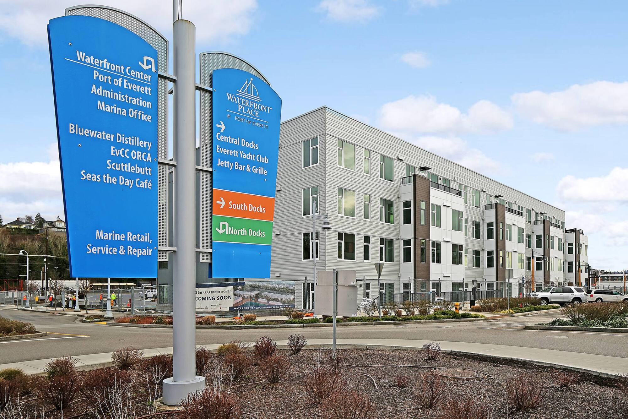 Waterfront Place apartments in Everett, WA behind waterfront district wayfinding signage on West Marine View Drive