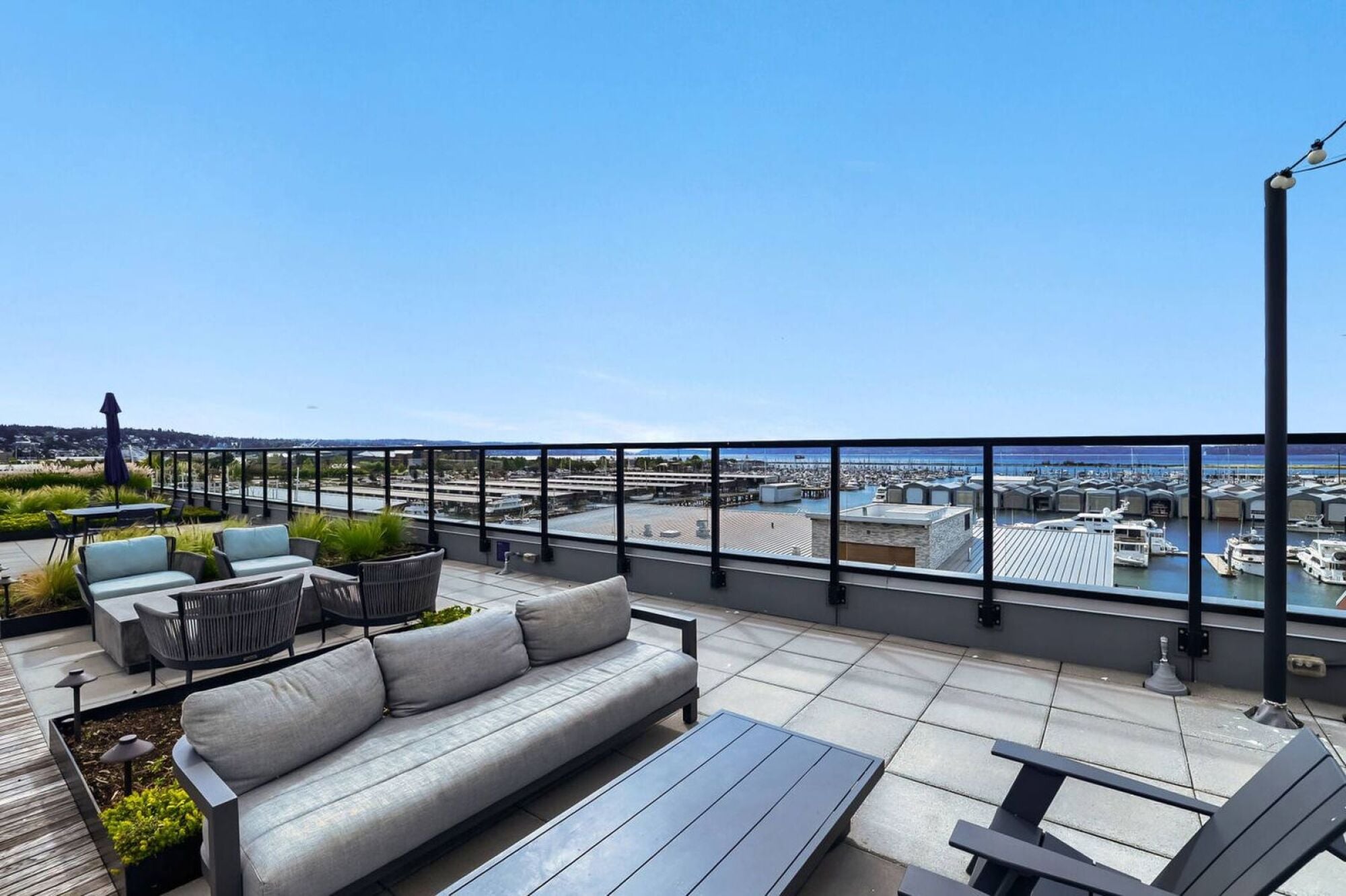 Rooftop deck seating overlooking the Everett, WA marina at Waterfront Place Apartments.