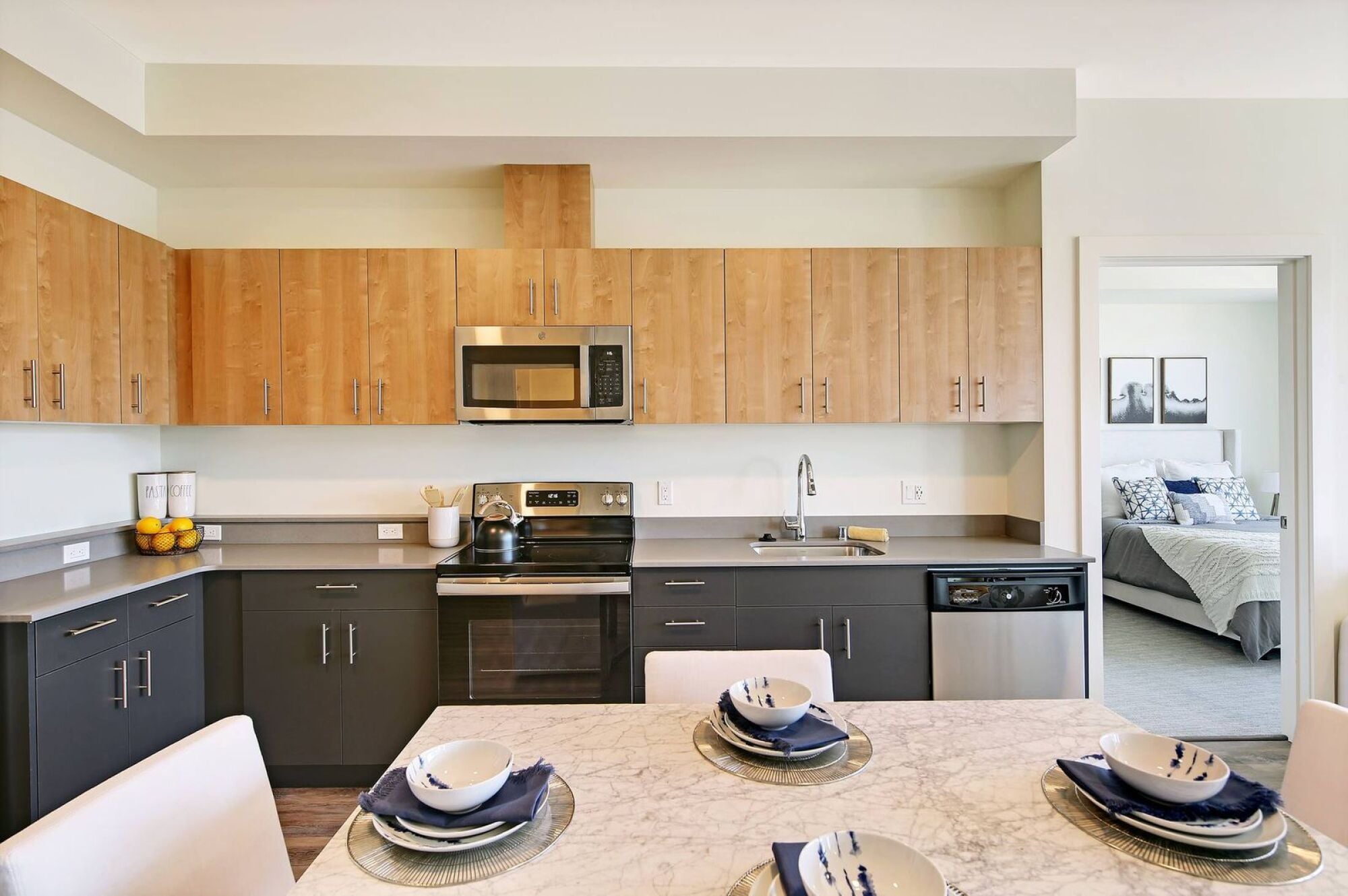 A kitchen opening to a bedroom at Waterfront Place Apartments in Everett, WA.