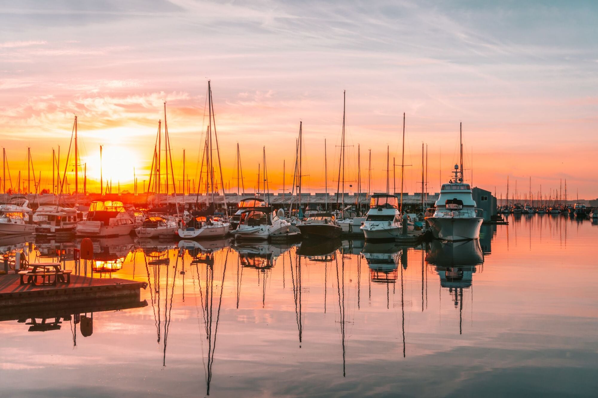 Sailboats moored at Everett's Central Marina at sunset near Waterfront Place in Everett, WA