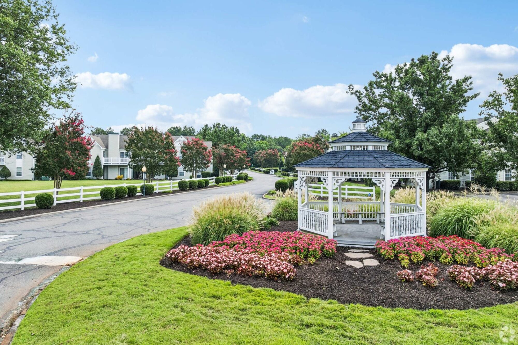 Oaks of Dunlop Farms in Colonial Heights, VA, white gazebo surrounded by flower beds, lawns, and apartment buildings.